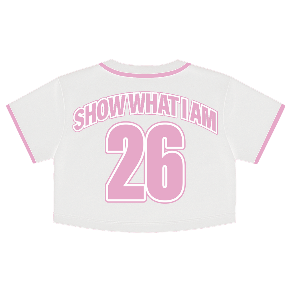 White cropped short-sleeve jersey top shown from the back, featuring pink trim on the collar and sleeve cuffs, with 'SHOW WHAT I AM' and the number '26' printed in pink on the back.