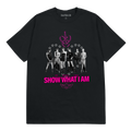 A black short-sleeve graphic t-shirt featuring a monochrome group photo of the K-pop group IVE, with a pink monogram logo above and the text 'SHOW WHAT I AM' in pink below.