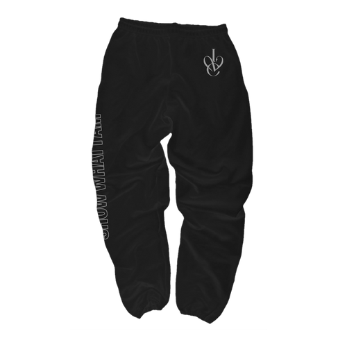 Black sweatpants with a white stylized 'IVE' logo on the upper left hip and vertical white text running down the right leg that says 'SHOW WHAT I AM'.