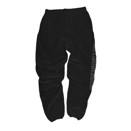 Black sweatpants with a white vertical graphic text print on the right leg that says 'SHOW WHAT I AM', shown from the back.