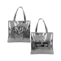 Metallic silver tote bag with front and back shown side by side. The left bag features a black graphic of a winged heart with a stylized 'IVE' monogram, and the right bag displays the text 'IVE WORLD TOUR SHOW WHAT I AM' in black.