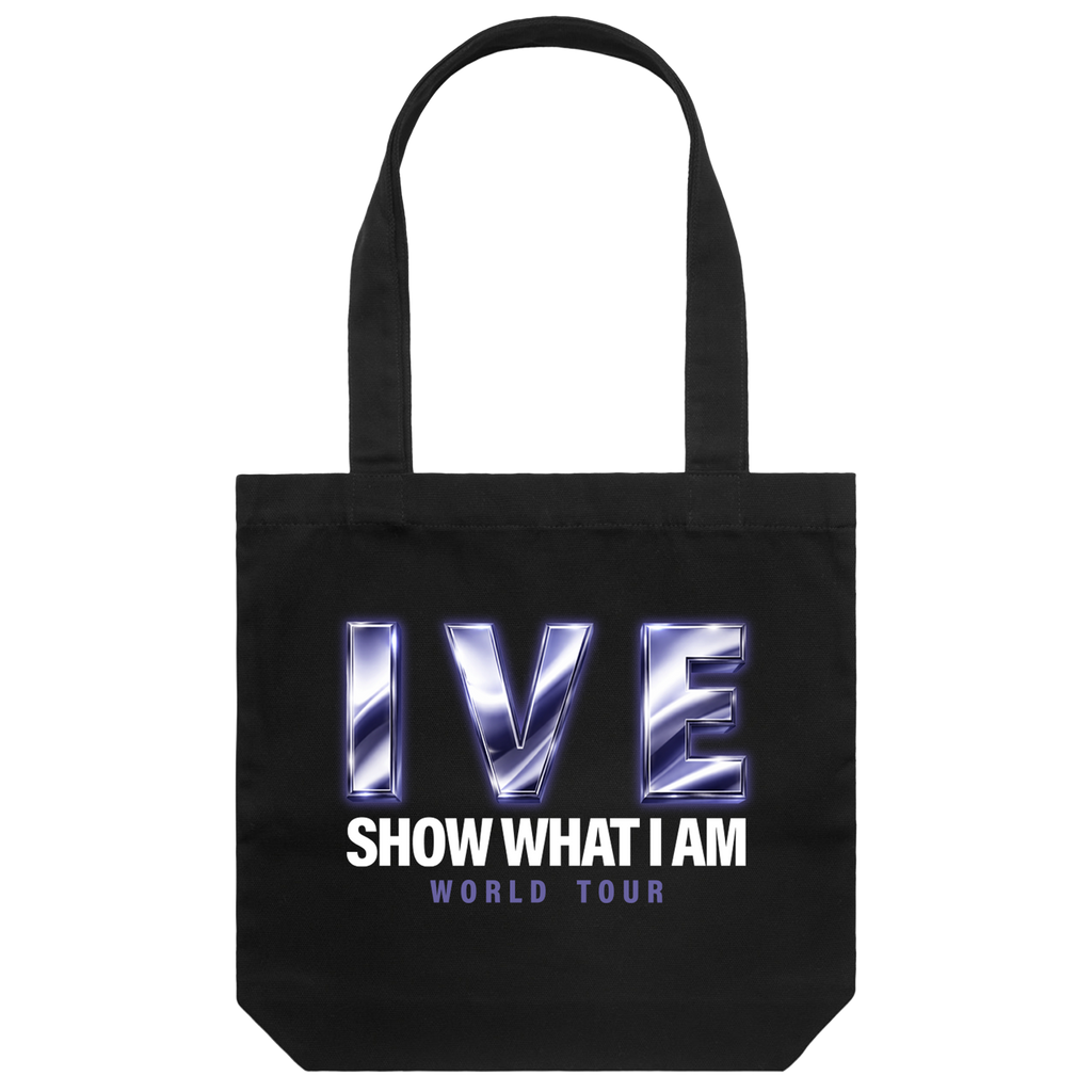 A black canvas tote bag featuring the band name 'IVE' in a metallic silver and blue gradient font, with 'SHOW WHAT I AM' and 'WORLD TOUR' printed below in white and light blue text.