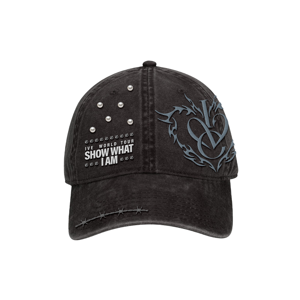 A distressed black baseball cap featuring a gray gothic-style 'IVE' logo on the side, white text reading 'IVE WORLD TOUR SHOW WHAT I AM' with small star accents on the front, and silver metal studs on the upper right panel.